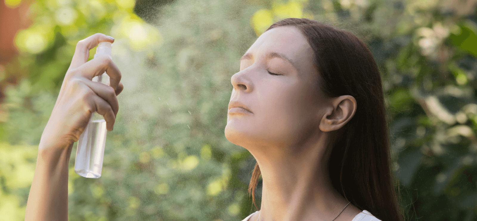 Woman misting her face