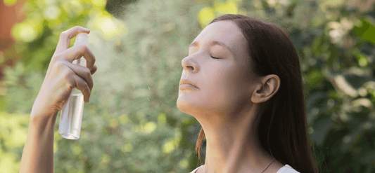 Woman misting her face
