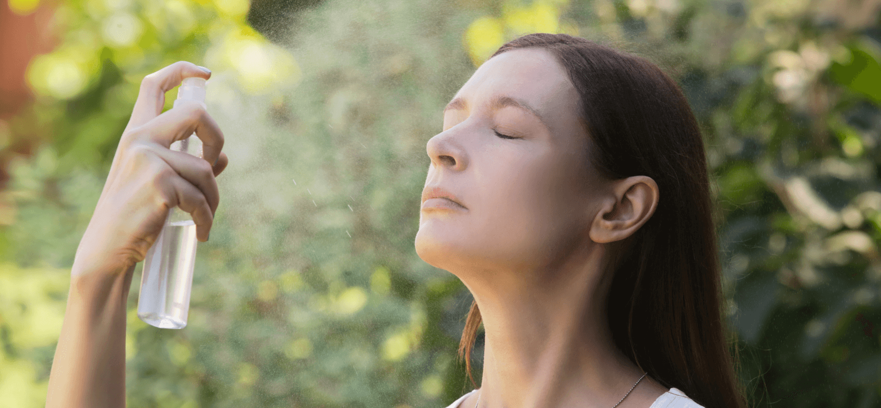 Woman misting her face