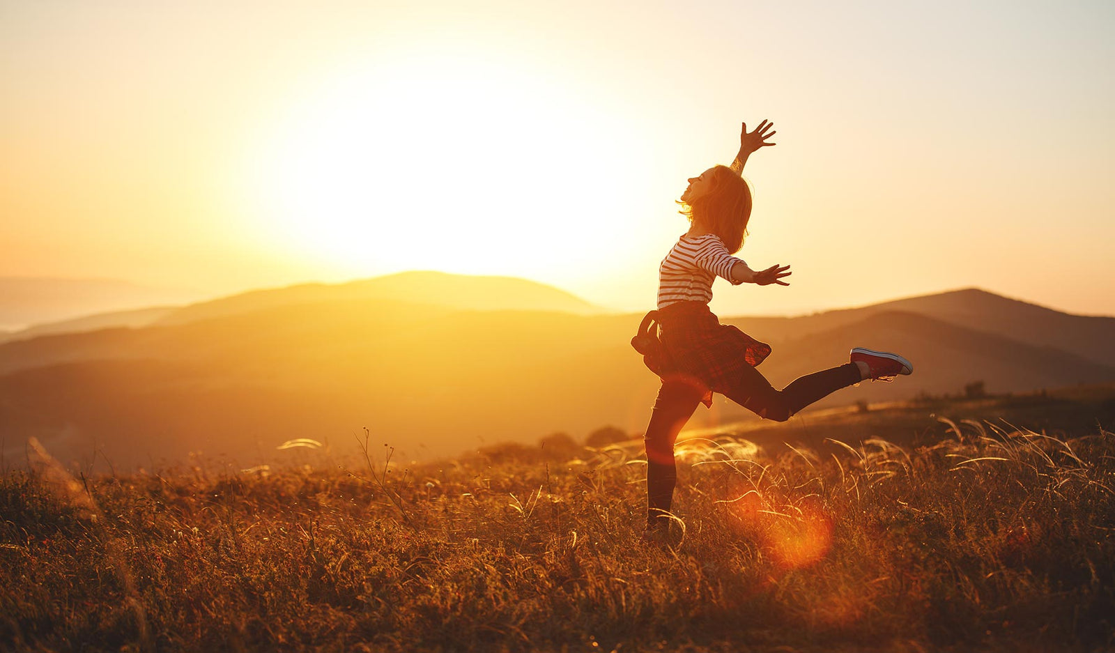 Woman joyfully running through field